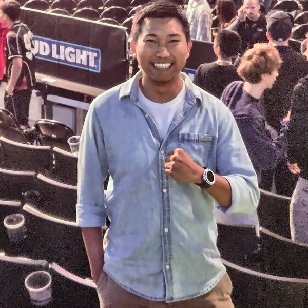 Min smiling in an arena on fight night
